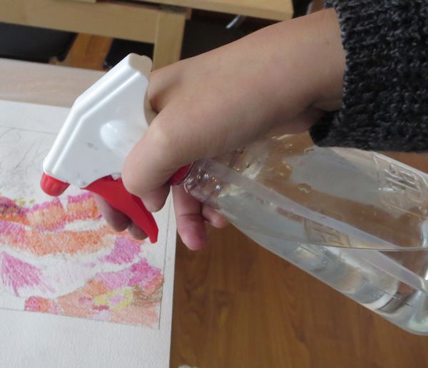 spraying paper with water