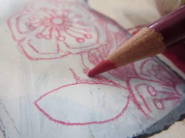 drawing zentangle patterns with a red colored pencil on top of the acrylic paint