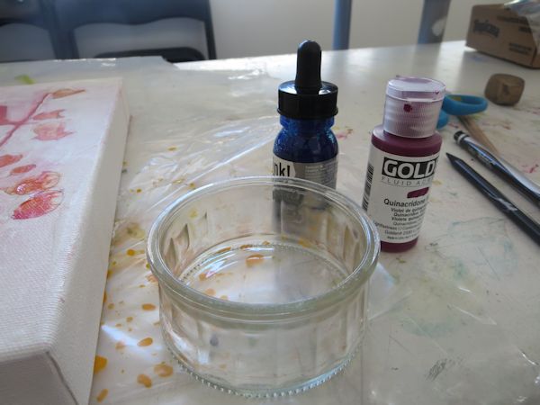mixing acrylic inks to paint over the background 