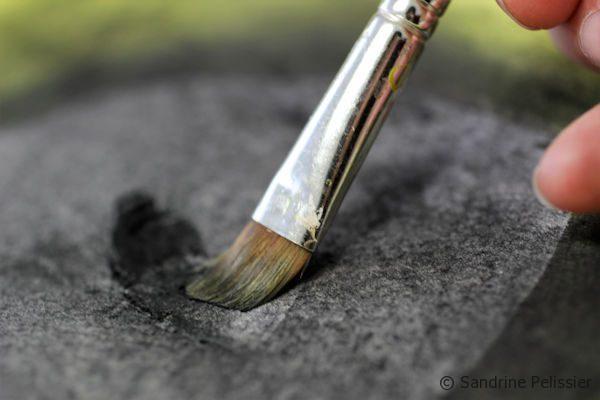 lifting off charcoal with a brush
